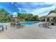 Beautiful community pool area with lounge chairs, palm trees, and ample space for residents to enjoy sunny days at 4061 Crockers Lake Blvd # 2611, Sarasota, FL 34238