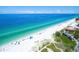 Expansive aerial view of a beach community with turquoise waters, white sand, and lush greenery at 4307 Gulf Dr # 208, Holmes Beach, FL 34217