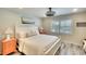 Cozy bedroom with white bedding, matching nightstands and plantation shutters at 4307 Gulf Dr # 208, Holmes Beach, FL 34217