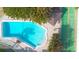 Overhead shot of a well-maintained community pool next to a shuffleboard court at 4307 Gulf Dr # 208, Holmes Beach, FL 34217