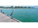 Picturesque view of a heron standing on a wooden dock overlooking a calm, blue body of water at 4307 Gulf Dr # 208, Holmes Beach, FL 34217