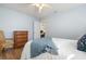 Bright bedroom featuring updated wood floor, a ceiling fan, and a view into another room at 4411 Violet Ave, Sarasota, FL 34233