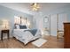 Charming bedroom with light blue walls, wood floor, ceiling fan, and updated sliding closet doors at 4411 Violet Ave, Sarasota, FL 34233