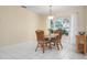 Dining room with a round table, three chairs, and a bright window view at 4411 Violet Ave, Sarasota, FL 34233