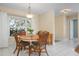 Sunlit dining room featuring a bay window and round wooden table at 4411 Violet Ave, Sarasota, FL 34233