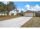 Wide driveway leading to a well-maintained home with mature trees in a sunny neighborhood at 4411 Violet Ave, Sarasota, FL 34233