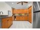 Well-lit kitchen featuring stainless steel refrigerator and ample cabinet space at 4411 Violet Ave, Sarasota, FL 34233