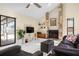 Bright living room featuring a stone fireplace and glass sliding door to patio at 4411 Violet Ave, Sarasota, FL 34233