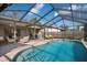 Lovely swimming pool surrounded by a screened enclosure and patio furniture for outdoor living at 4411 Violet Ave, Sarasota, FL 34233