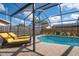 Gorgeous pool with lounge chairs and a screened enclosure for outdoor relaxation at 4411 Violet Ave, Sarasota, FL 34233