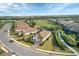 Scenic aerial shot of a neighborhood with golf course views, shimmering lakes, and beautiful homes with tile roofs at 4543 Terrazza Ct, Lakewood Ranch, FL 34211