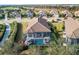 An aerial view of a home with a screened in pool and view of the golf course at 4543 Terrazza Ct, Lakewood Ranch, FL 34211