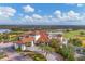 Beautiful clubhouse with a terracotta roof, surrounded by well-manicured gardens and lush green spaces in a golf community at 4543 Terrazza Ct, Lakewood Ranch, FL 34211