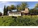 Elegant stone community entrance sign surrounded by lush landscaping and mature palm trees at 4543 Terrazza Ct, Lakewood Ranch, FL 34211