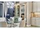 Dining area with a glass table, seating for six, a decorative chandelier, and a wine storage area at 4543 Terrazza Ct, Lakewood Ranch, FL 34211