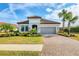 Charming one-story home with a well-manicured lawn, beautiful landscaping, and a brick paved driveway and walkway at 4543 Terrazza Ct, Lakewood Ranch, FL 34211