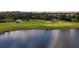 Golf course view shows players on the green near a pond with sand traps at 4543 Terrazza Ct, Lakewood Ranch, FL 34211