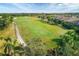 Scenic aerial view of a lush green golf course, showcasing pristine fairways and mature landscaping in a resort-style community at 4543 Terrazza Ct, Lakewood Ranch, FL 34211