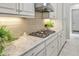 Close-up of a kitchen counter featuring stainless steel appliances, a gas cooktop, and granite countertops at 4543 Terrazza Ct, Lakewood Ranch, FL 34211