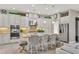 Well-lit kitchen featuring stainless steel appliances, granite countertops, an island, and stylish barstool seating at 4543 Terrazza Ct, Lakewood Ranch, FL 34211