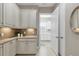 Kitchen area features white cabinets and granite countertops, conveniently located near a laundry room at 4543 Terrazza Ct, Lakewood Ranch, FL 34211