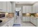 Well lit kitchen with white cabinets, granite countertops, stainless steel sink, and tile backsplash at 4543 Terrazza Ct, Lakewood Ranch, FL 34211