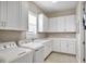 Bright laundry room with white cabinets, tile floors, and a washer and dryer at 4543 Terrazza Ct, Lakewood Ranch, FL 34211