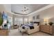 Well-lit main bedroom featuring tray ceilings, plantation shutters, and neutral decor at 4543 Terrazza Ct, Lakewood Ranch, FL 34211