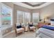 Seating area in main bedroom featuring a pool view through plantation shutters at 4543 Terrazza Ct, Lakewood Ranch, FL 34211