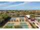 A high angle view of pickleball courts in a community with beautiful landscaping and shade structures at 4543 Terrazza Ct, Lakewood Ranch, FL 34211