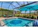 Screened in pool and patio with a dining set and view of the golf course at 4543 Terrazza Ct, Lakewood Ranch, FL 34211