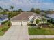 Aerial view showcasing the home's tile roof, landscaping, and spacious driveway at 5063 Timber Chase Way, Sarasota, FL 34238