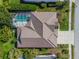 Stunning aerial view of the home showcasing its well-maintained roof, screened-in pool, and lush landscaping at 5063 Timber Chase Way, Sarasota, FL 34238