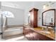 Bright bathroom featuring double sinks with granite counters and a large soaking tub at 5063 Timber Chase Way, Sarasota, FL 34238