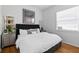 Cozy bedroom with hardwood floors, neutral tones, and ample natural light from a large window at 5063 Timber Chase Way, Sarasota, FL 34238