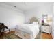 Cozy bedroom with a tufted headboard, wooden floors, and a stylish area rug at 5063 Timber Chase Way, Sarasota, FL 34238