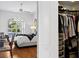 Partial view of bedroom with an attached closet showcasing organized storage at 5063 Timber Chase Way, Sarasota, FL 34238