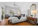 Elegant bedroom with a tufted headboard, bench, and a view of the pool area at 5063 Timber Chase Way, Sarasota, FL 34238