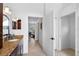 Hallway view featuring a vanity and sink, a bedroom, and hallway access at 5063 Timber Chase Way, Sarasota, FL 34238