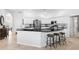 Kitchen featuring black countertops, white cabinets, and stainless steel appliances at 5063 Timber Chase Way, Sarasota, FL 34238