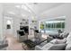 Bright living room with built-in shelving, comfortable seating, and sliding glass doors leading to the pool area at 5063 Timber Chase Way, Sarasota, FL 34238