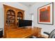 Office with wooden desk and bookcase, featuring modern art and sophisticated decor at 5063 Timber Chase Way, Sarasota, FL 34238