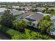 Rear view of home highlighting the screened-in pool and lush landscaping at 5063 Timber Chase Way, Sarasota, FL 34238