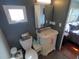 Charming bathroom featuring white vanity, toilet, medicine cabinet, and a window at 5075 Tri Par Dr, Sarasota, FL 34234