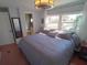 Inviting bedroom with hardwood floors, a view, and a light fixture at 5075 Tri Par Dr, Sarasota, FL 34234