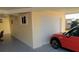 Attached garage with a white door and ample space for parking at 5075 Tri Par Dr, Sarasota, FL 34234