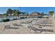 Community pool area featuring ample lounge seating under the sun and a covered tiki hut at 5075 Tri Par Dr, Sarasota, FL 34234