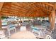 Inviting tiki bar area with tables and chairs, providing a relaxing space for socializing and enjoying refreshments at 5075 Tri Par Dr, Sarasota, FL 34234