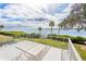 Relaxing balcony with white railing overlooking water and clear blue sky with two lounge chairs facing scenic waterfront views at 55 Tidy Island Blvd, Bradenton, FL 34210