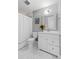 Well-lit bathroom with a vanity, toilet, and shower featuring classic white fixtures at 55 Tidy Island Blvd, Bradenton, FL 34210